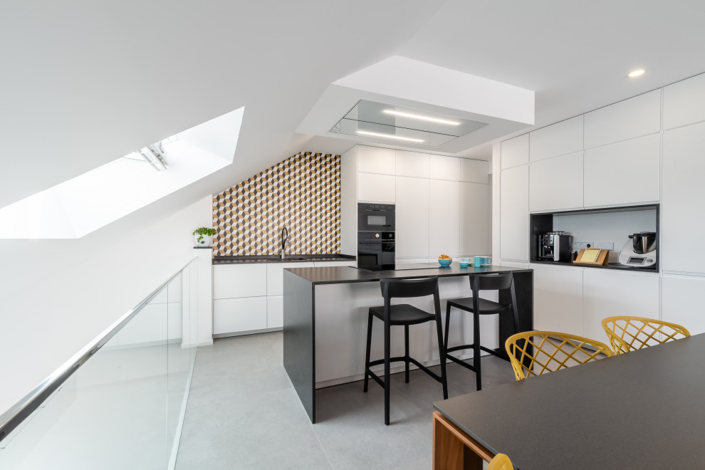 Inspiration for a large contemporary l-shaped porcelain tile and gray floor eat-in kitchen remodel in Other with an undermount sink, flat-panel cabinets, white cabinets, quartz countertops, an island, black countertops, multicolored backsplash and black appliances