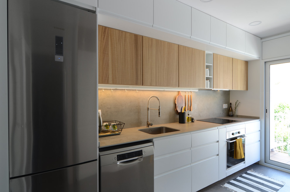 Example of a mid-sized trendy single-wall gray floor kitchen design in Barcelona with an undermount sink, white cabinets, gray backsplash, stainless steel appliances, gray countertops, flat-panel cabinets and no island