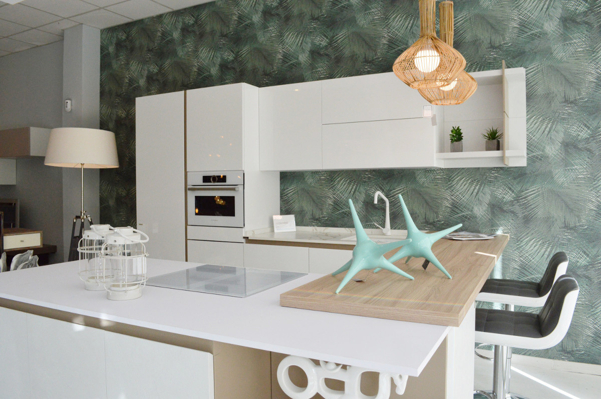 Example of a beach style white floor open concept kitchen design in Seville with flat-panel cabinets, white cabinets, laminate countertops, white appliances and a peninsula