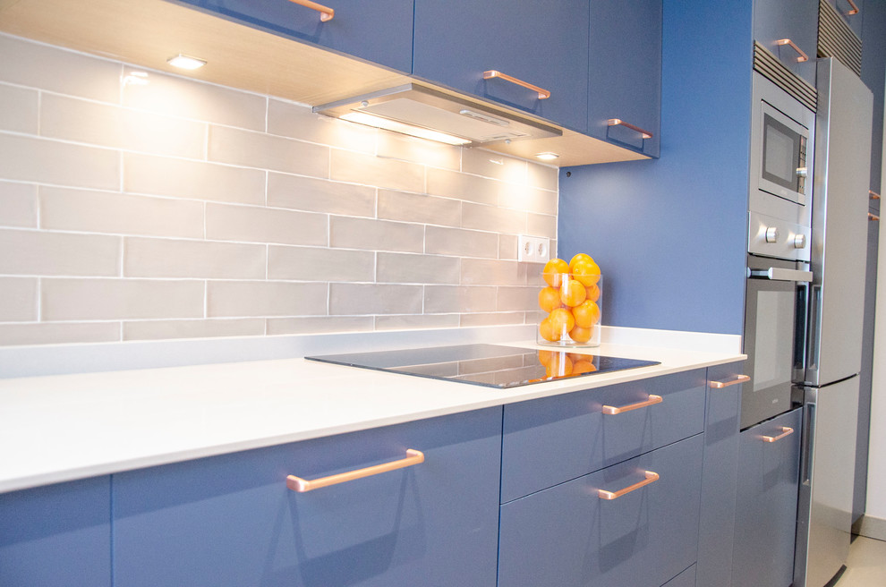 Mid-sized single-wall enclosed kitchen photo in Madrid with blue cabinets, quartz countertops, no island and white countertops