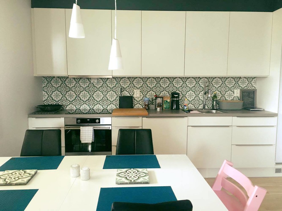Ejemplo de cocina contemporánea con salpicadero verde y salpicadero de azulejos de cemento