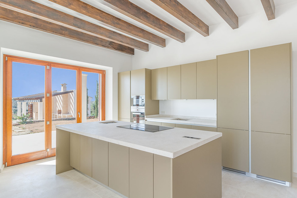 Cette image montre une cuisine parallèle design avec un placard à porte plane, un électroménager en acier inoxydable, îlot, des portes de placard beiges, un sol beige et un plan de travail blanc.