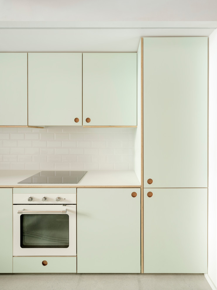 Design ideas for a small scandi single-wall open plan kitchen in Madrid with a built-in sink, shaker cabinets, green cabinets, laminate countertops, white splashback, ceramic splashback, stainless steel appliances, concrete flooring, no island, grey floors and green worktops.