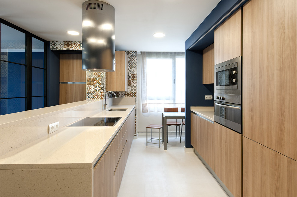 This is an example of a medium sized traditional galley enclosed kitchen in Other with a submerged sink, flat-panel cabinets, medium wood cabinets, engineered stone countertops, stainless steel appliances, porcelain flooring, mirror splashback and no island.
