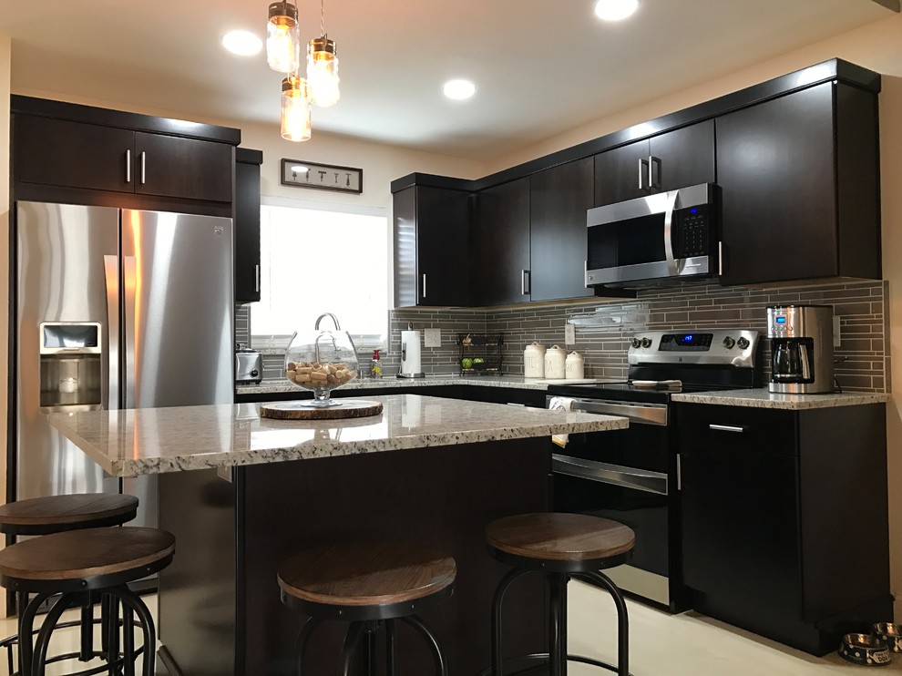 Medium sized contemporary kitchen/diner in Tampa with stainless steel appliances, porcelain flooring, an island, beige floors and black cabinets.