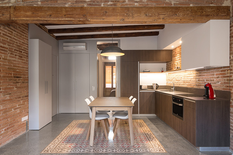 Eat-in kitchen - mid-sized industrial l-shaped eat-in kitchen idea in Barcelona with an undermount sink, flat-panel cabinets, dark wood cabinets, quartz countertops, paneled appliances, no island and brown backsplash