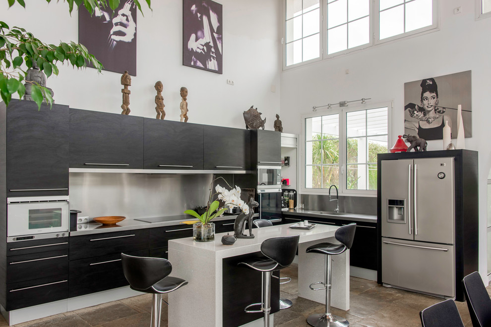 Mid-sized mid-century modern l-shaped open concept kitchen photo in Other with a single-bowl sink, flat-panel cabinets, black cabinets, white backsplash and an island