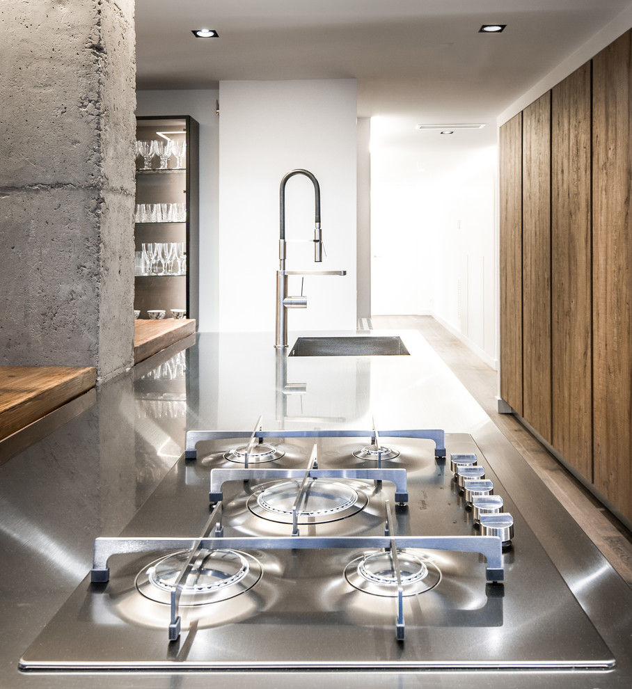 Design ideas for a medium sized world-inspired enclosed kitchen in Barcelona with an island.
