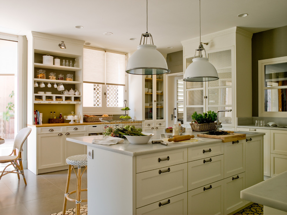 Mid-sized farmhouse u-shaped ceramic tile eat-in kitchen photo in Barcelona with recessed-panel cabinets, white cabinets and an island