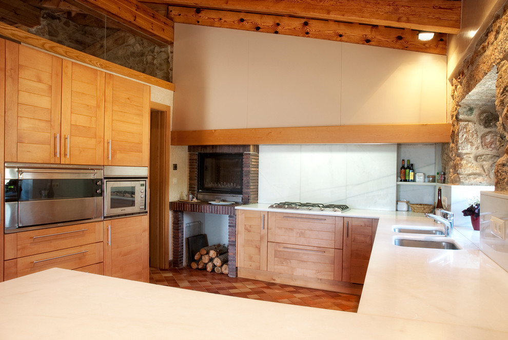 Inspiration for a medium sized rustic u-shaped open plan kitchen in Other with a double-bowl sink, raised-panel cabinets, medium wood cabinets, white splashback, stainless steel appliances, terracotta flooring and a breakfast bar.