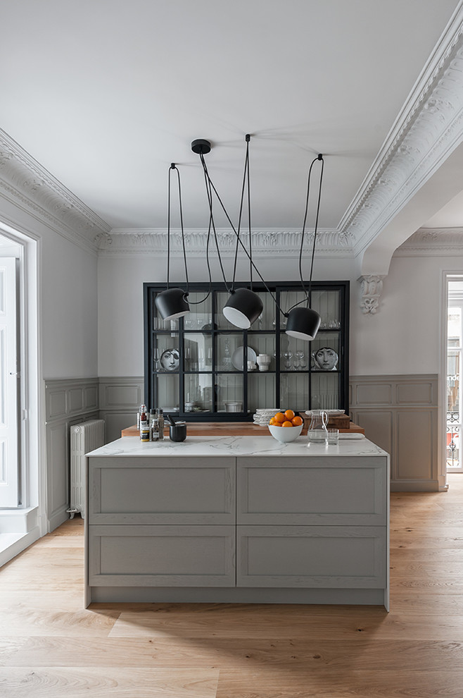 Example of a large trendy light wood floor open concept kitchen design in Other with a single-bowl sink, raised-panel cabinets, gray cabinets, marble countertops, white backsplash, marble backsplash, stainless steel appliances, an island and white countertops