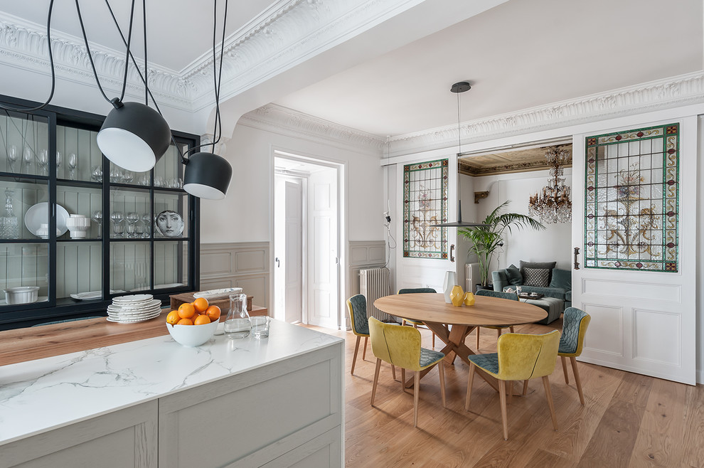 Design ideas for a large eclectic eat-in kitchen in Other with light hardwood floors, brown floor, a single-bowl sink, raised-panel cabinets, grey cabinets, marble benchtops, white splashback, marble splashback, stainless steel appliances, with island and white benchtop.