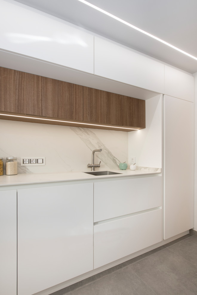 Large scandinavian galley enclosed kitchen in Other with a single-bowl sink, flat-panel cabinets, white cabinets, engineered stone countertops, white splashback, black appliances, terracotta flooring, no island, grey floors and white worktops.