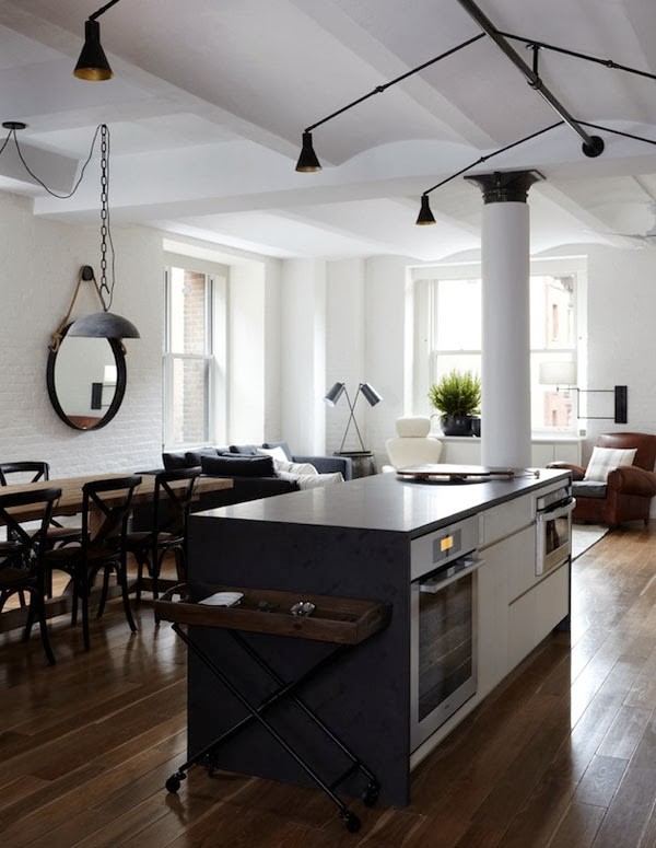 This is an example of a large traditional open plan kitchen in Madrid with stainless steel appliances and an island.