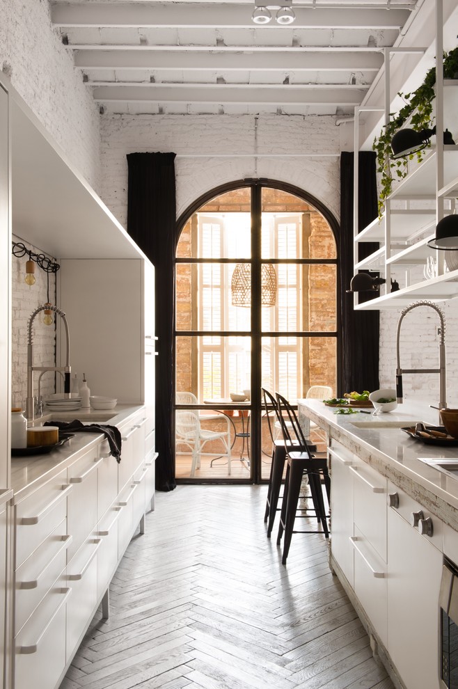 Large shabby-chic style galley kitchen/diner in Other with flat-panel cabinets, white cabinets, white splashback, cement tile splashback, painted wood flooring and no island.