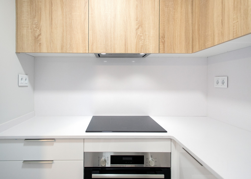 Example of a mid-sized trendy u-shaped ceramic tile and beige floor open concept kitchen design in Barcelona with a single-bowl sink, flat-panel cabinets, white cabinets, white backsplash, stainless steel appliances, no island and white countertops