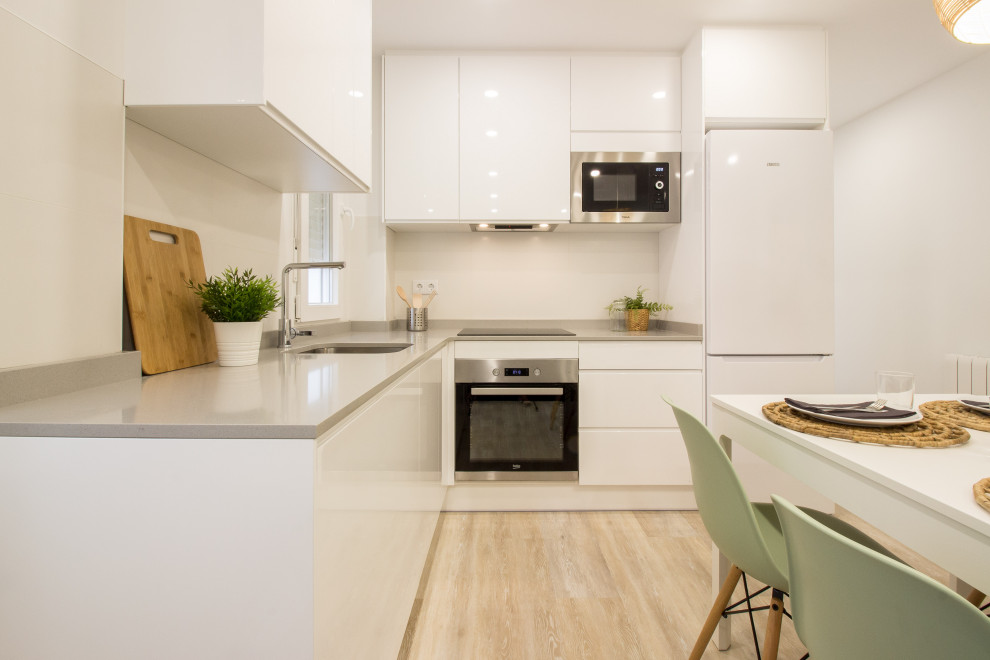 Foto de cocina escandinava abierta sin isla con armarios con paneles lisos, puertas de armario blancas, encimera de cuarzo compacto y encimeras grises