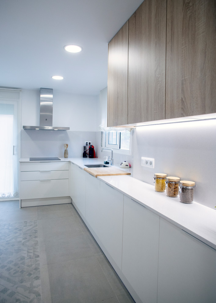 Inspiration for a large contemporary l-shaped enclosed kitchen remodel in Barcelona with a single-bowl sink, flat-panel cabinets, white cabinets, white backsplash, stainless steel appliances, no island and white countertops