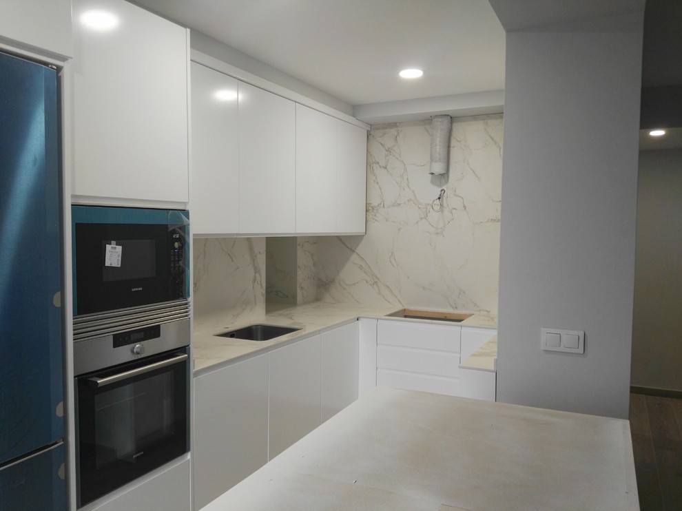 Inspiration for a small contemporary u-shaped open plan kitchen in Other with a submerged sink, flat-panel cabinets, white cabinets and ceramic flooring.