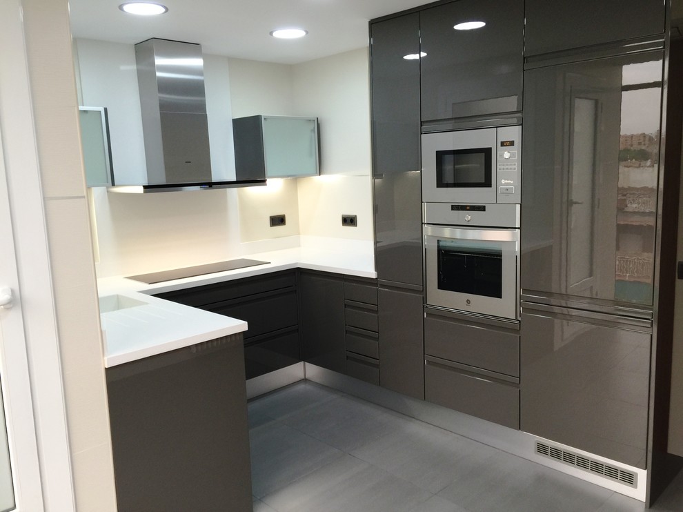 Medium sized contemporary u-shaped enclosed kitchen in Other with flat-panel cabinets, grey cabinets and no island.