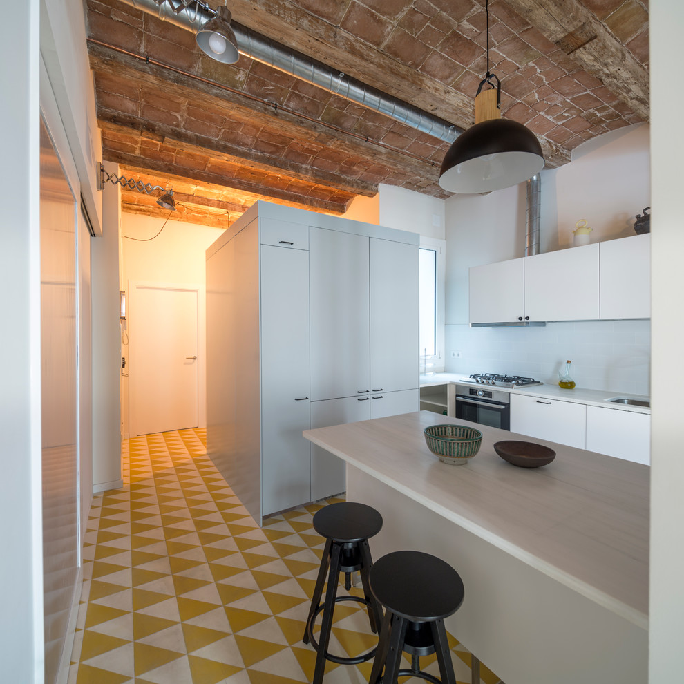 Photo of a medium sized industrial u-shaped kitchen/diner in Barcelona with flat-panel cabinets, white cabinets, white splashback, ceramic flooring and no island.