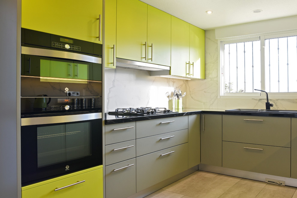 Small minimalist l-shaped kitchen photo in Alicante-Costa Blanca with flat-panel cabinets, green cabinets and no island