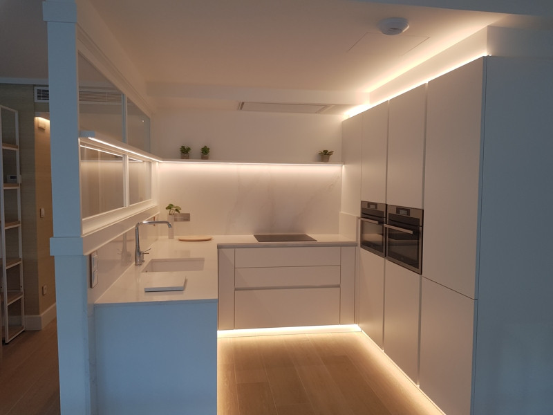 This is an example of a kitchen in Other with white worktops.