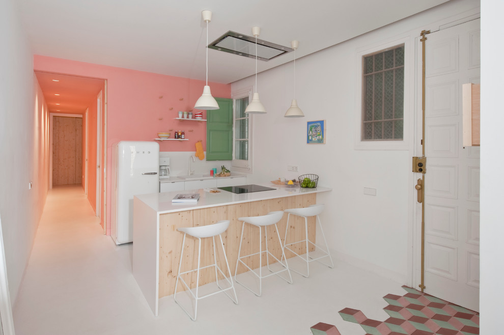 Eat-in kitchen - mid-sized contemporary galley eat-in kitchen idea in Barcelona with a drop-in sink, flat-panel cabinets, white cabinets, solid surface countertops, white backsplash and a peninsula