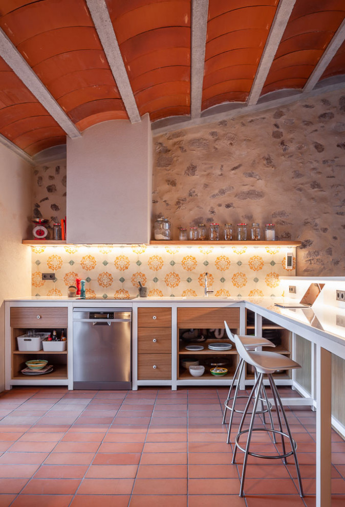 Inspiration for a medium sized mediterranean l-shaped kitchen/diner in Other with a single-bowl sink, open cabinets, medium wood cabinets, marble worktops, multi-coloured splashback, mosaic tiled splashback, stainless steel appliances, porcelain flooring, red floors, white worktops and a breakfast bar.