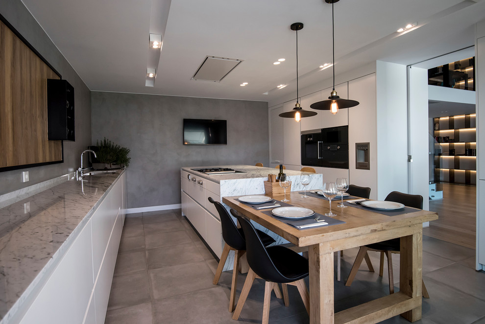 Immagine di una cucina contemporanea con ante lisce, ante bianche, lavello sottopiano, pavimento grigio e top grigio