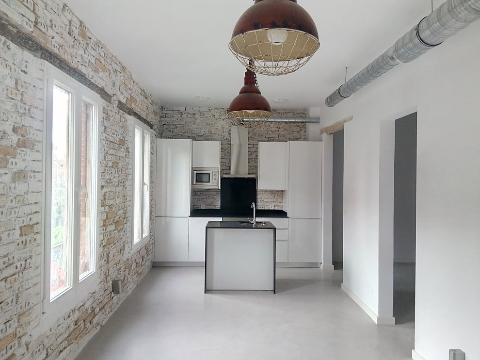 Inspiration for a small urban single-wall open plan kitchen in Madrid with a single-bowl sink, flat-panel cabinets, white cabinets, white appliances and an island.