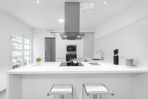 Sleek and Modern: Achieve a Modern Look with Gray Kitchen Appliances in an All-White Kitchen