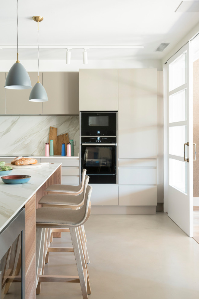 Large contemporary open plan kitchen in Barcelona with a single-bowl sink, flat-panel cabinets, beige cabinets, marble worktops, white splashback, marble splashback, stainless steel appliances, dark hardwood flooring, an island, brown floors and white worktops.