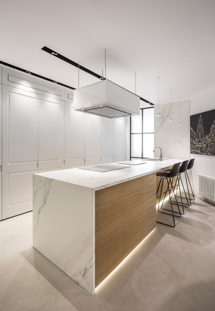 Esempio di una grande cucina contemporanea chiusa con lavello sottopiano, elettrodomestici da incasso, pavimento in cemento, pavimento grigio e top bianco