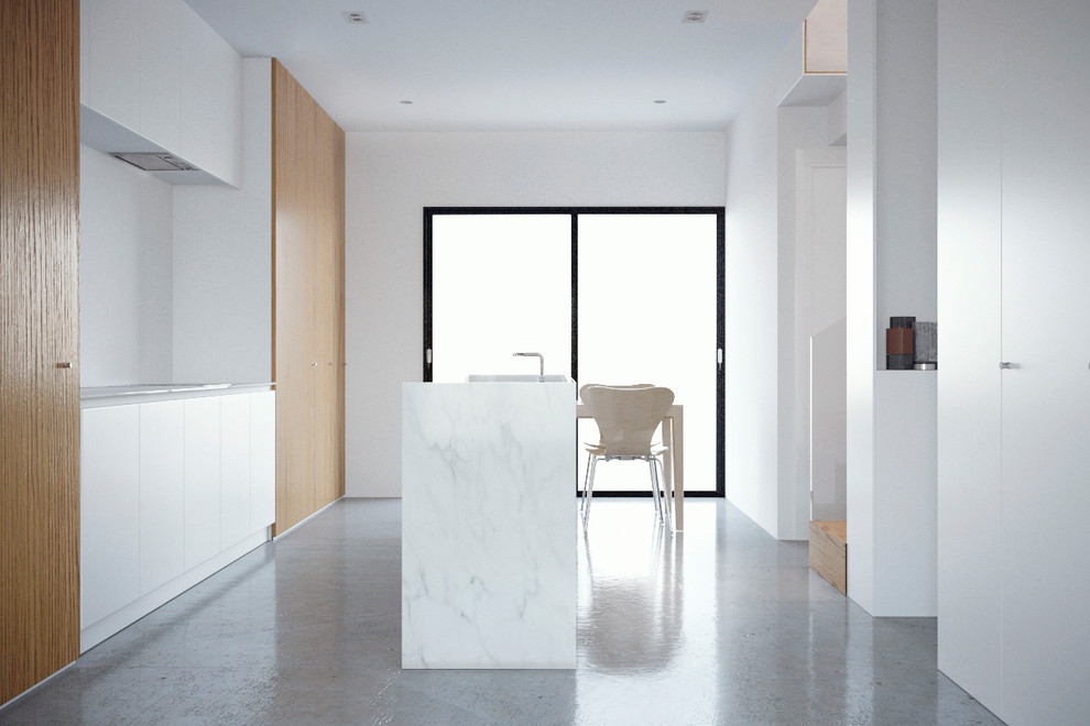 Esempio di una cucina minimalista di medie dimensioni con ante con riquadro incassato, ante in legno scuro, top in quarzo composito, pavimento in cemento, pavimento grigio e top bianco