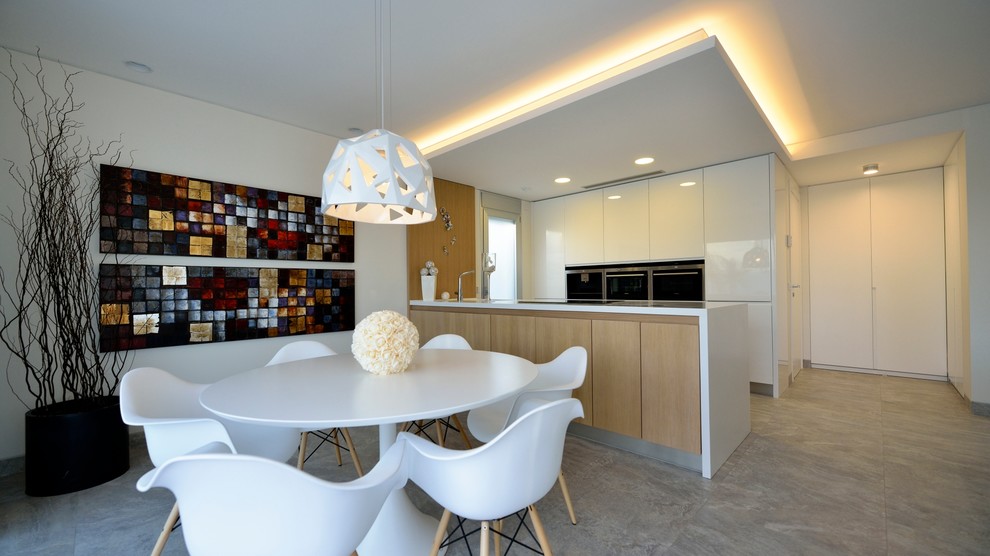 На фото: кухня-столовая среднего размера в скандинавском стиле с белыми стенами и полом из керамической плитки без камина