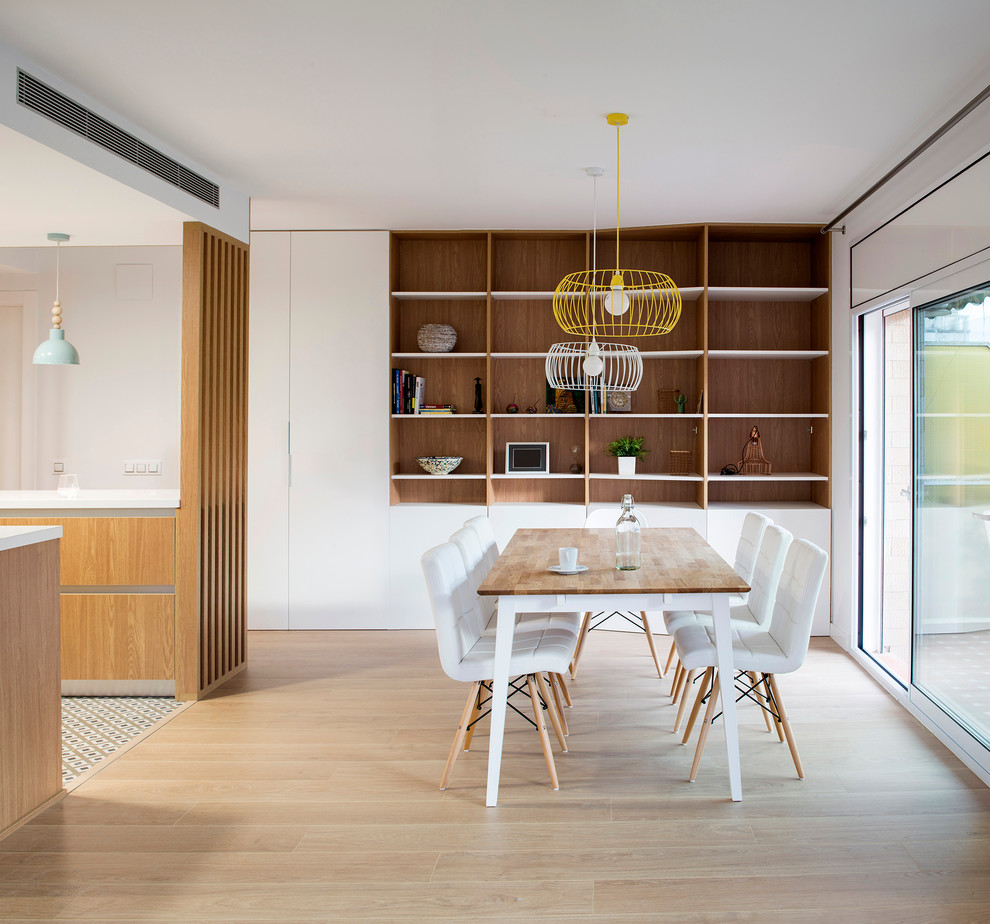 Example of a mid-sized danish light wood floor great room design in Barcelona with white walls and no fireplace