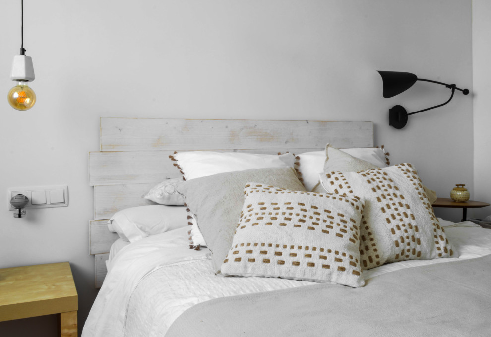 Design ideas for a scandi bedroom in Other with white walls and light hardwood flooring.