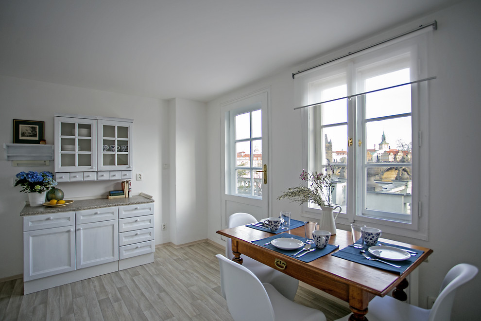 Idee per una sala da pranzo aperta verso la cucina chic con pareti bianche e pavimento beige