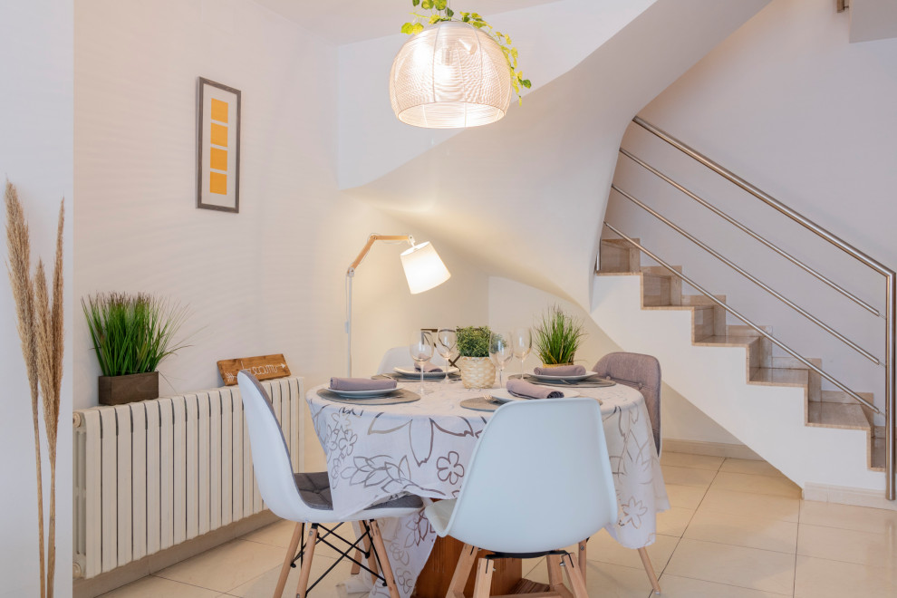 Cette photo montre une salle à manger ouverte sur le salon méditerranéenne de taille moyenne avec un mur blanc, un sol en carrelage de céramique et un sol beige.