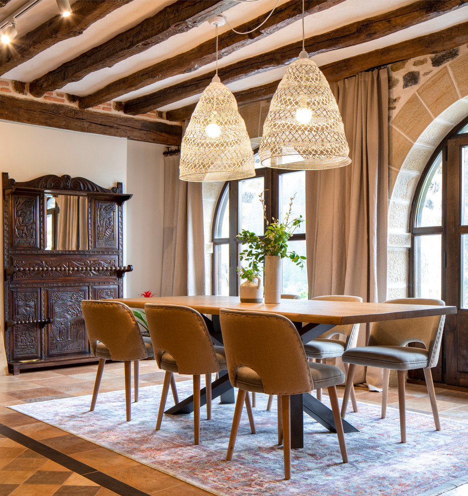 Example of a tuscan brown floor dining room design in Bilbao with beige walls