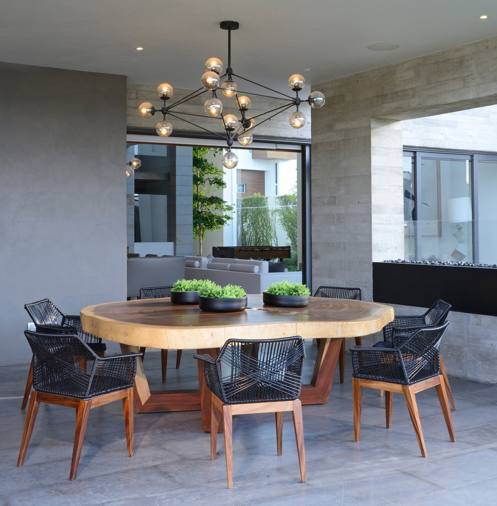 Contemporary dining room in Mexico City with grey walls and grey floors.