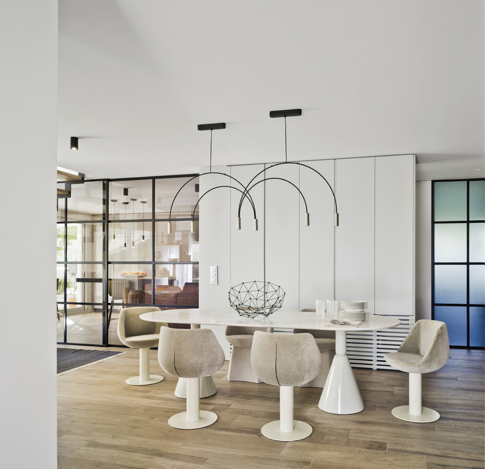 Inspiration for a contemporary dining room in Other with white walls, light hardwood flooring and beige floors.
