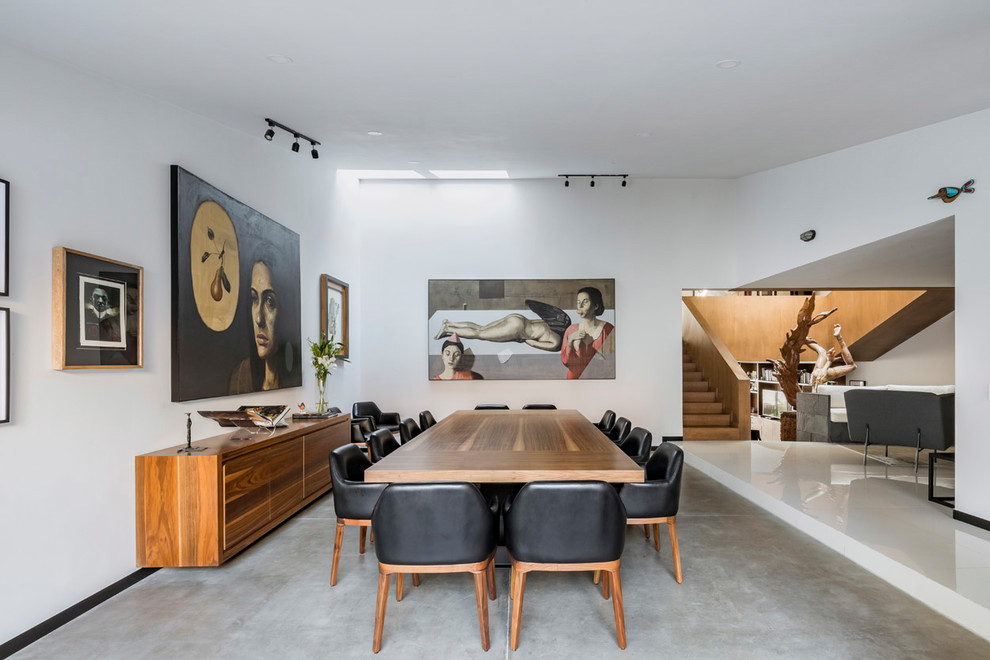 Dining room - contemporary concrete floor and gray floor dining room idea in Mexico City with white walls
