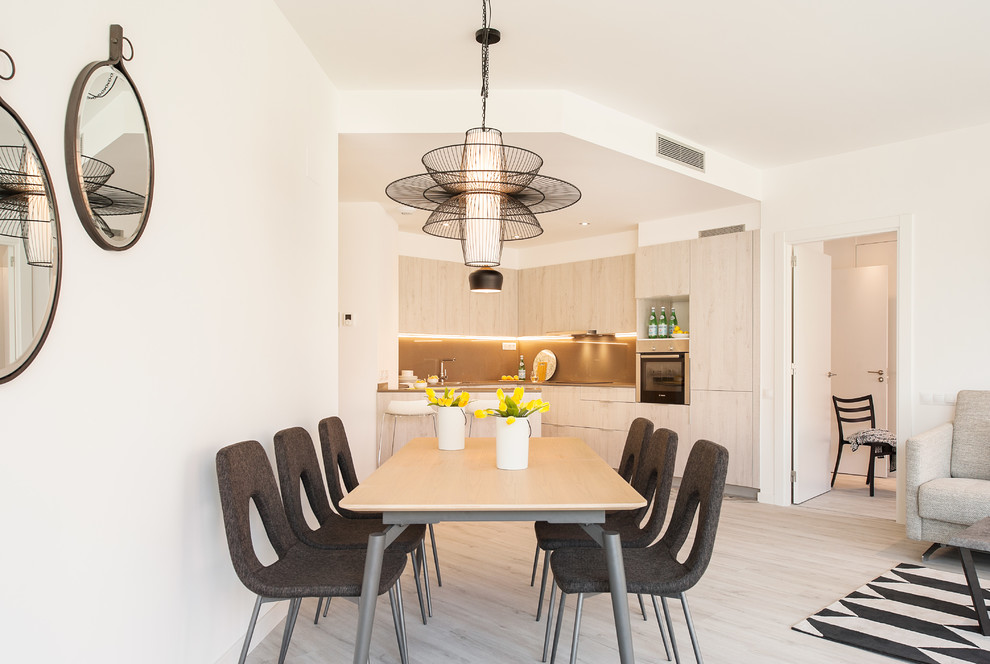 Inspiration for a medium sized contemporary open plan dining room in Barcelona with white walls, light hardwood flooring, beige floors and no fireplace.