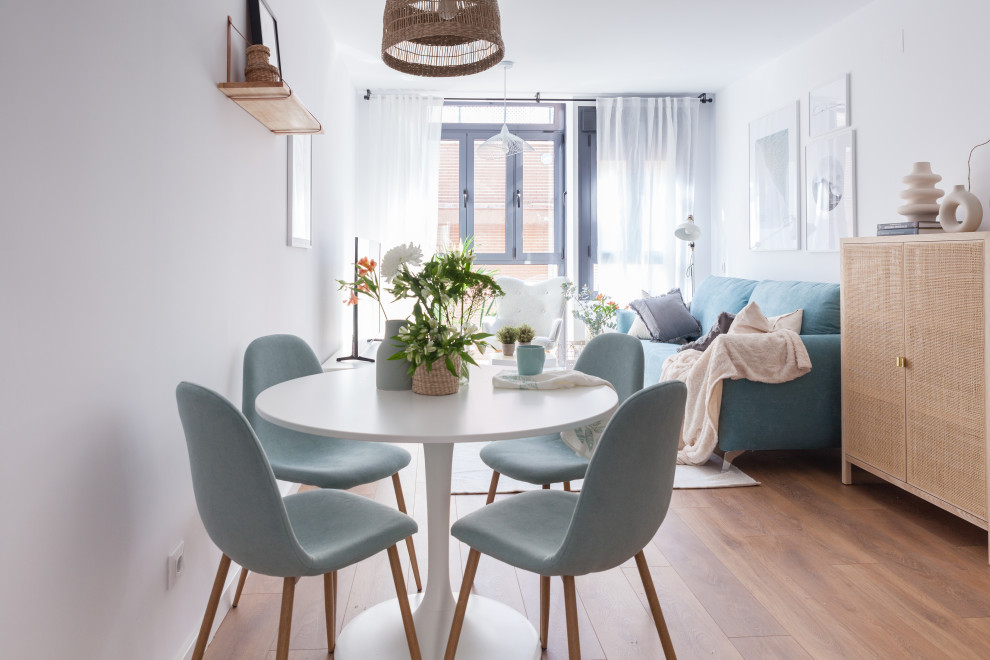 Photo of a small scandinavian open plan dining room in Madrid with white walls, medium hardwood flooring and brown floors.