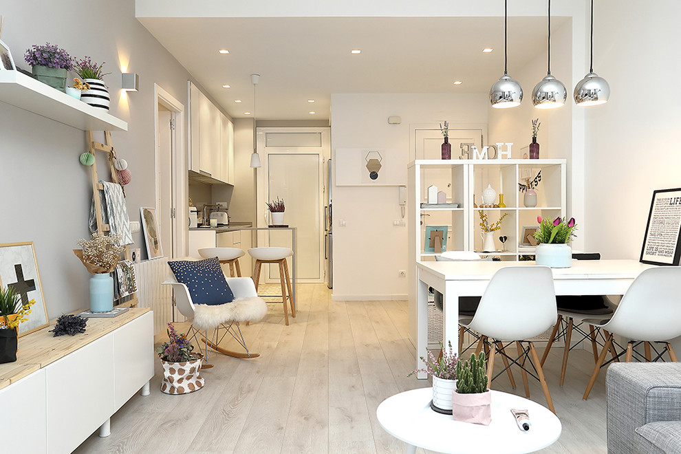 Стильный дизайн: маленькая гостиная-столовая в скандинавском стиле с белыми стенами и светлым паркетным полом без камина для на участке и в саду - последний тренд