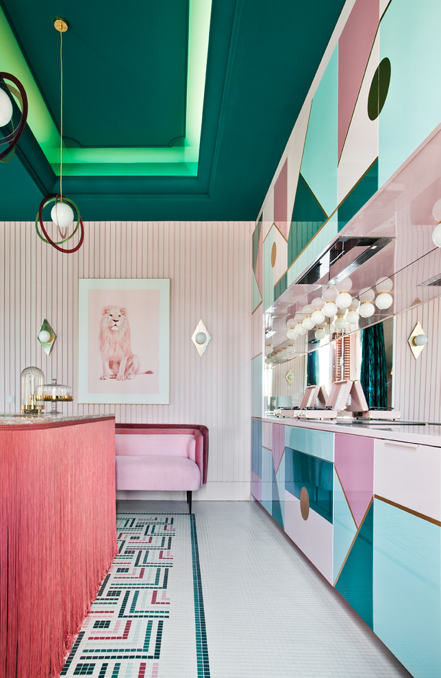 Expansive eclectic kitchen/dining room in Madrid with pink walls and multi-coloured floors.