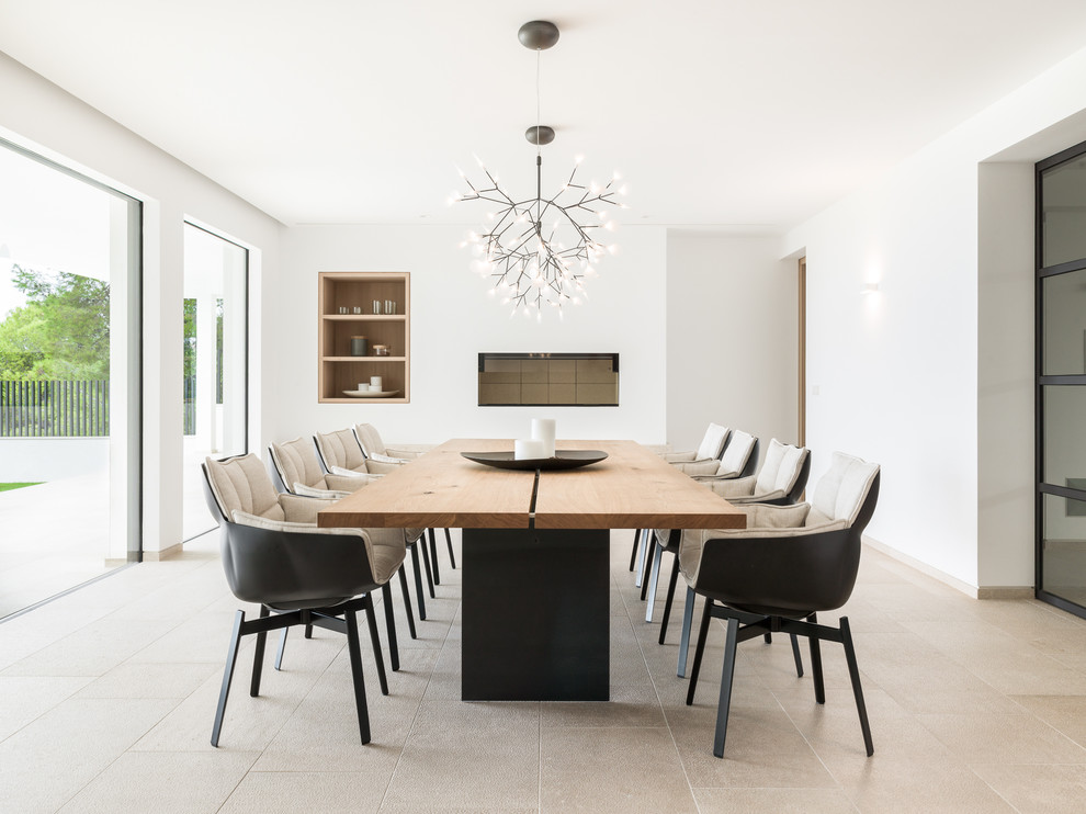 Inspiration for a large contemporary dining room in Palma de Mallorca with white walls and beige floors.