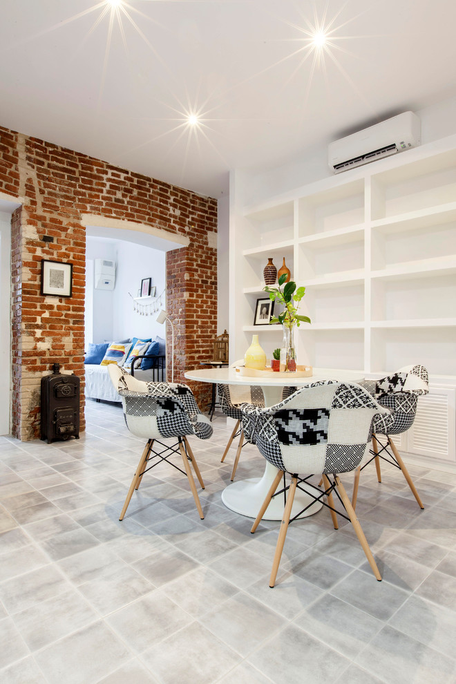 This is an example of a medium sized industrial open plan dining room in Madrid with white walls, ceramic flooring and no fireplace.